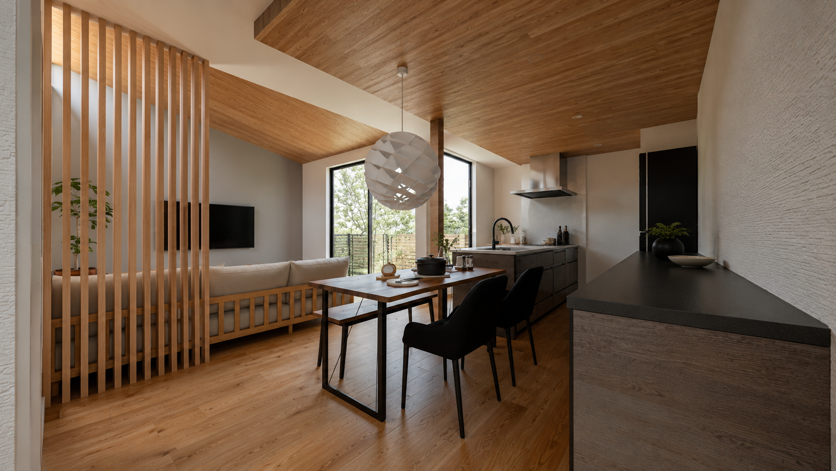 Open-plan living and dining area with a wooden slat divider, a long wooden table, black chairs, and a modern kitchen island under a wood-paneled ceiling.